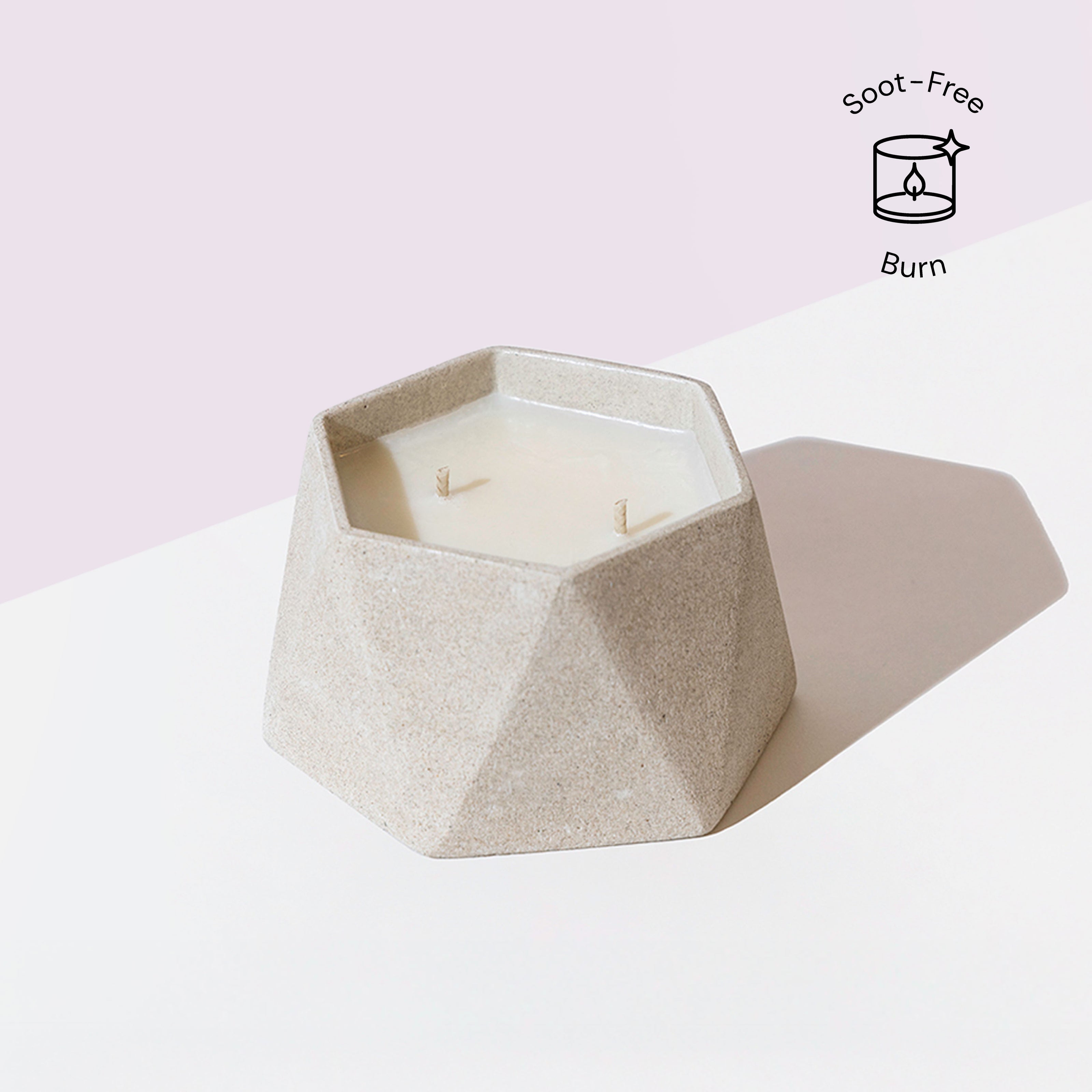 Eraya Aesthetic hexagonal Soy wax candle in a textured holder with 'Soot-Free Burn' icon on a light pink background