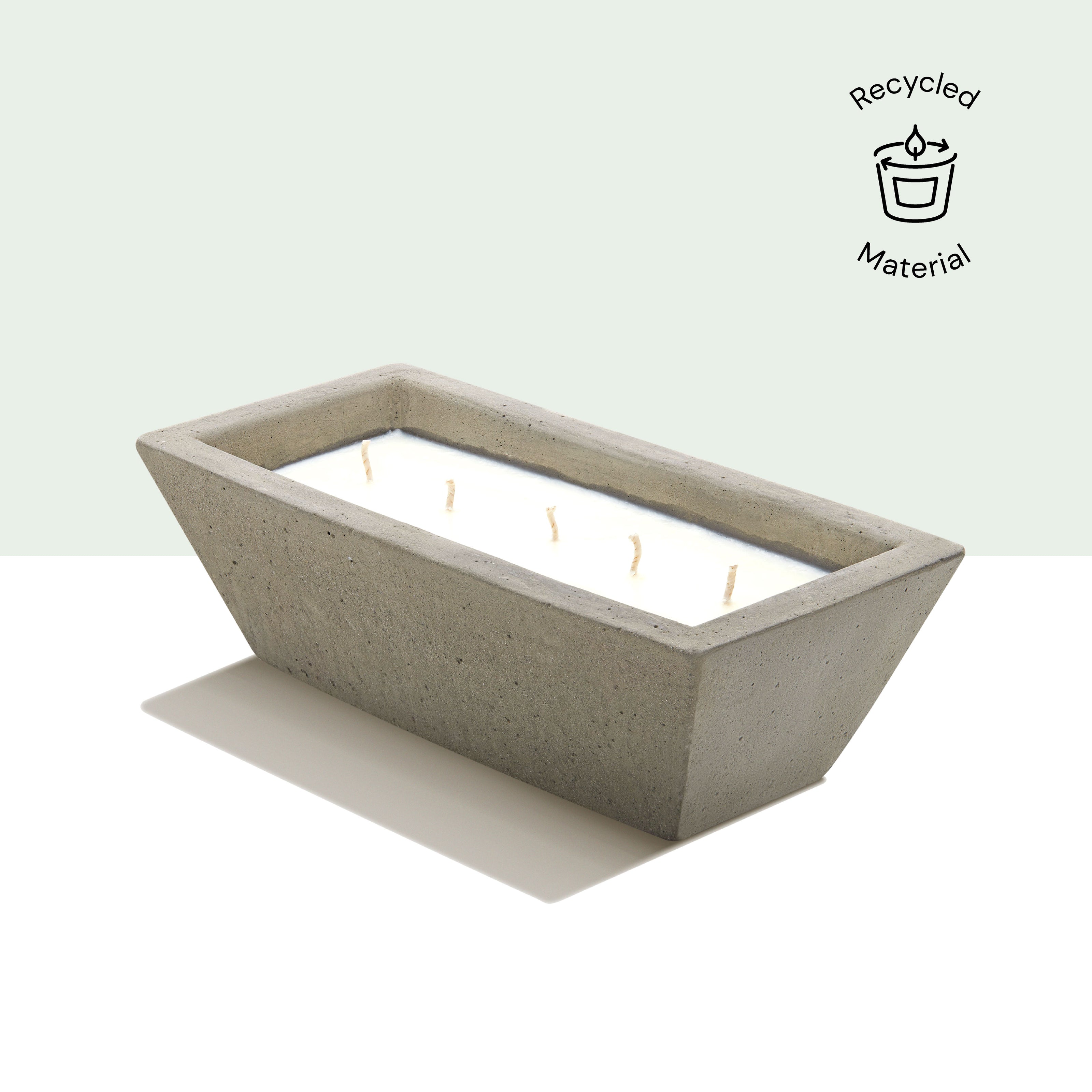 Eraya Aesthetic Rectangular concrete soy wax candle on a light green background, featuring a 'Recycled Material' icon.