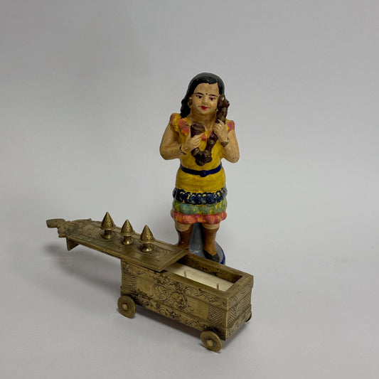 Decorative figurine of a woman with a cart on a white background